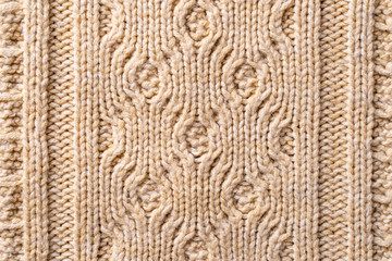 Beige Knitwear Fabric Texture with Pigtails. Beige Knitted Background.