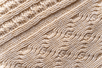 Beige Knitwear Fabric Texture with Pigtails. Beige Knitted Background.