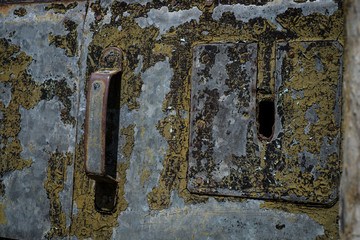 Old rusted metal door in seaside village of Tellaro, Italy