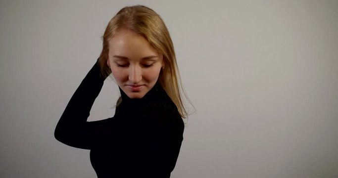woman in black clothes changes poses in studio slow motion
