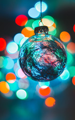 Fototapeta premium Vertical glass see-through globe with beautiful Christmas lights bokeh background