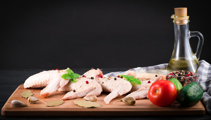 Fresh and raw meat. Chicken wings white ready to cook. Background black blackboard.