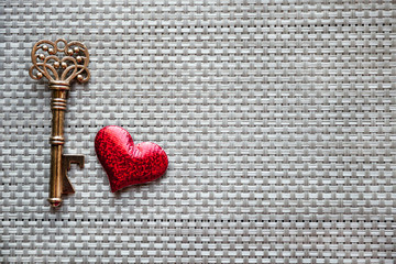 the key heart on the background of the Mat , top view