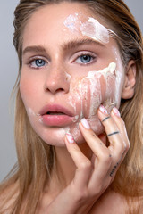beauty portrait of a girl using skin care cosmetics - 306034670