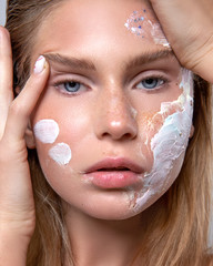 beauty portrait of a girl using skin care cosmetics - 306034694