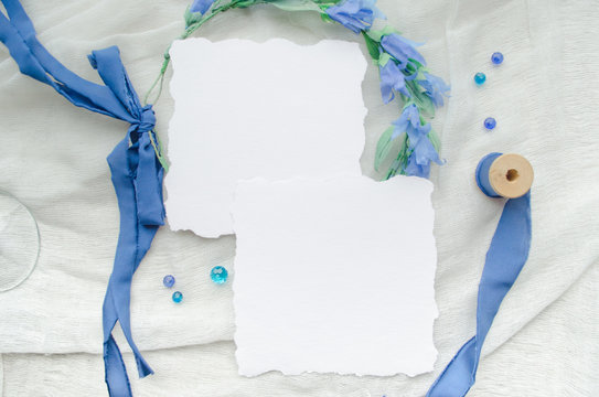 Blue wedding invitation set mockup decorated with silk ribbon, crystals and bride wreath