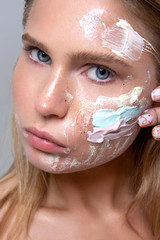 beauty portrait of a girl using skin care cosmetics - 306035691