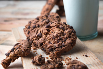 Chocolate chip cookies on a wooden background with milk. No people. Concept raw food. Front