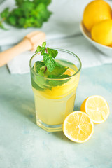 Glass of fresh lemonade on table