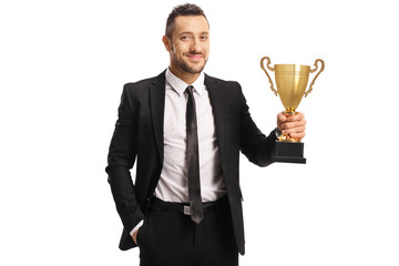 Young man in a suit and tie holding a trophy