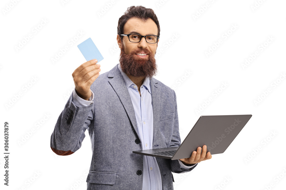 Wall mural bearded man holding a laptop and a credit card