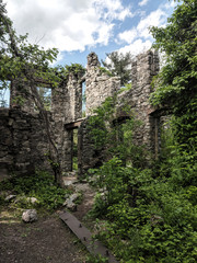 Fototapeta na wymiar Van Slyke Castle ruins hidden in the woods at Ramapo Reservation. New Jersey. Haunting remains of Foxcroft from 1900's.