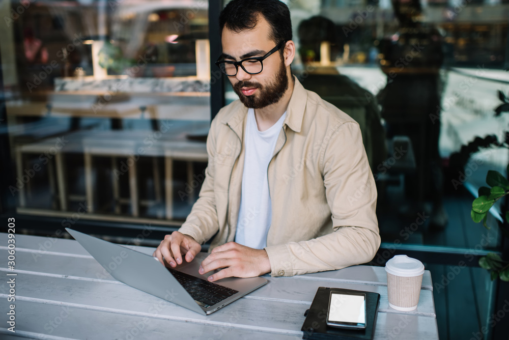 Aufkleber smart bearded male copywriter satisfied with remote job browsing web pages on laptop computer sittin