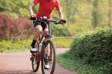 Fototapeta na wymiar Woman cyclist riding mountain bike outdoors