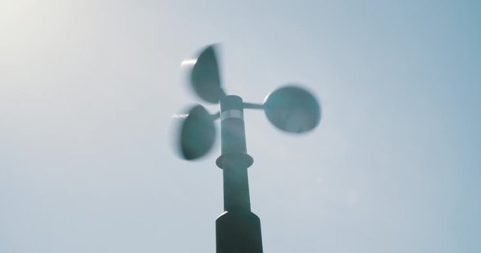 Anemometer spinning closeup with lense flare showing wind speed
