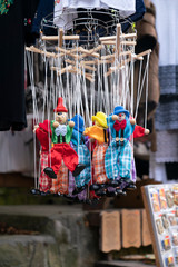 Several old and handmade puppets at a street market stall in Sinaia, Romania