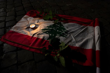 Rome Italy, November 22, 2019: Lebanese flag with two red roses and a candle