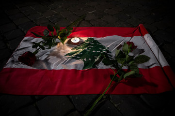 Rome Italy, November 22, 2019: Lebanese flag with two red roses and a candle