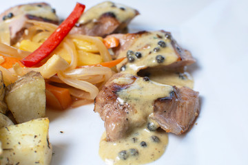 meat in passion fruit sauce, steamed potatoes and salad