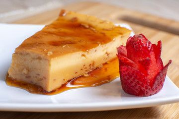  caramel flan decorated with chopped strawberry