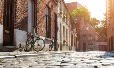 Bicycles at old building facade, cozy street