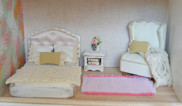 Dollhouse, bedroom with bed and armchair and pink carpet