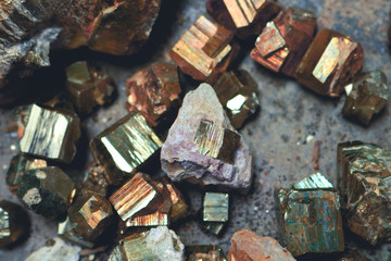 geometric pyrite ore pieces with colorful metallic texture in cube and irregular shapes - closeup treasure