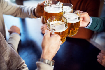 Friends toasting with beer,close up