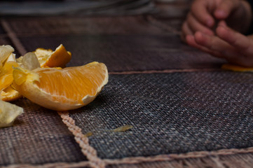 Orange on the table.Child  holding a fruit