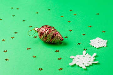 Christmas decoration on the green background. Ornaments, snowflakes, stars. Copy space.