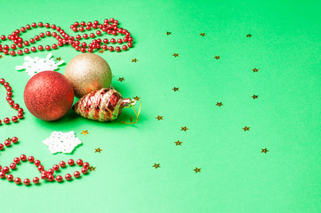 Christmas decoration on the green background. Ornaments, snowflakes, stars. Copy space.