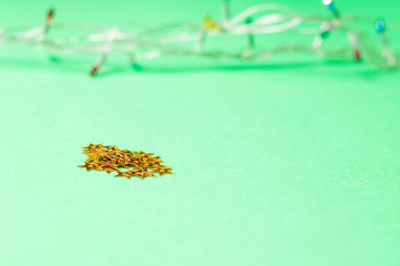 Christmas decoration on the green background. Ornaments, snowflakes, stars. Copy space.