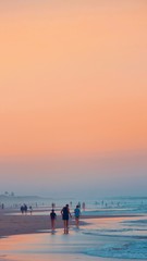 Fototapeta premium couple walking on the beach at sunset