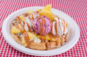 waffles with ice cream, chopped fruit and sauces