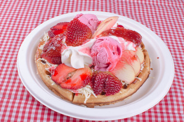 waffles with ice cream, chopped fruit and sauces
