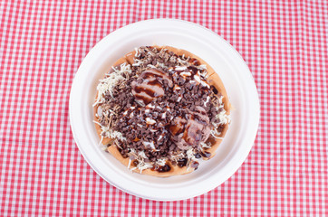 waffles with ice cream, chopped fruit and sauces
