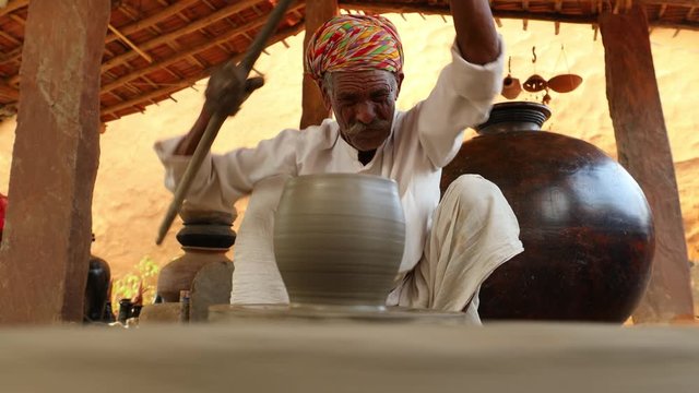 Potter at work makes ceramic dishes. India, Rajasthan.