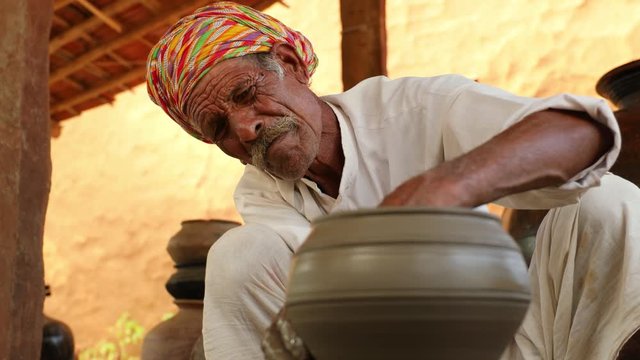 Potter at work makes ceramic dishes. India, Rajasthan.