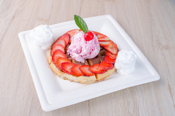 waffles with ice cream, chopped fruit and sauces