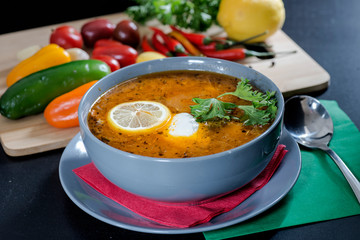 plate with solyanka with vegetables on the table
