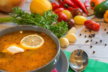 plate with solyanka with vegetables on the table