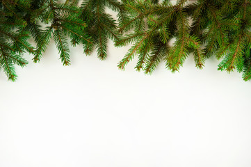 Obraz premium Christmas composition. The border is made of spruce branches on a white background. Christmas, winter, New year.