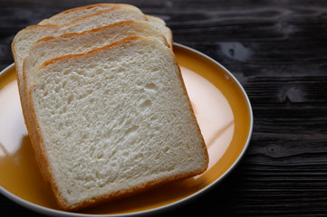 Fresh homemade  baked bread and sliced bread on wooden