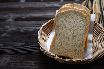 Fresh homemade  baked whole grain bread and sliced bread on wooden