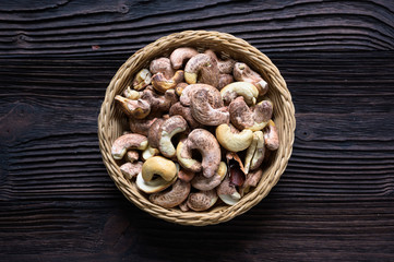 Roasted cashews on natural wooden table background