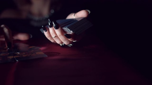 4k Mysterious Shot of Fortune Teller Placing on Table Tarot Cards