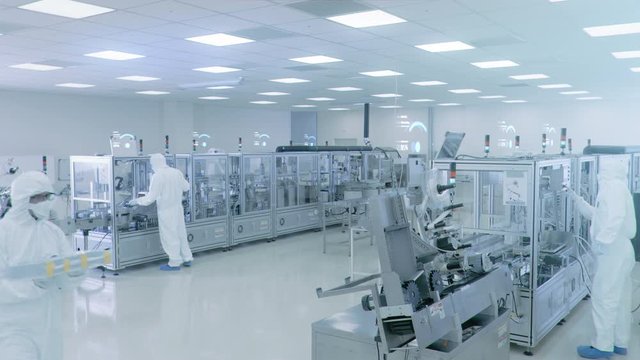 Manufacturing Facility Workers Assembling Products Using Industrial High Precision Machinery. Special Effects Animation: Wi-Fi Connected Icons with Completion Progress