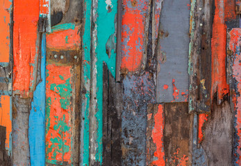 Patterned and textures background of brightly colored panels of weathered painted wooden boards.