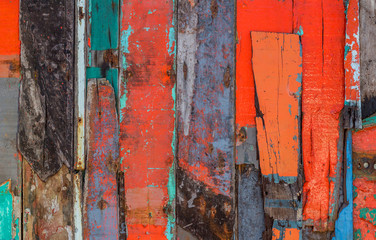 Patterned and textures background of brightly colored panels of weathered painted wooden boards.