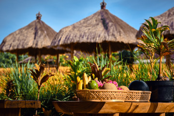 Fresh fruits on a plate in Interior of a traditional Balinese cafe in a rice field. Ubud, Bali, Indonesia.